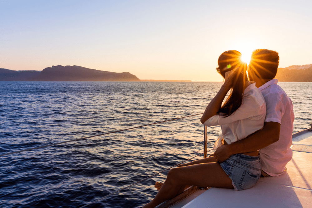 a person sitting next to a body of water