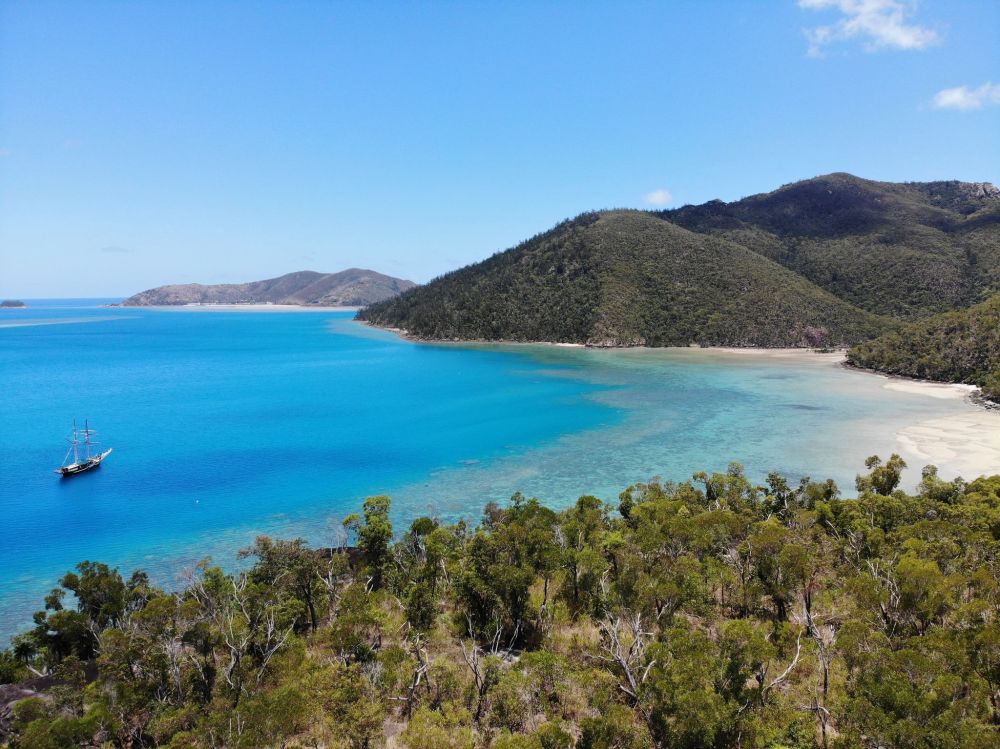 an island in the middle of a body of water with Two Peoples Bay Nature Reserve in the background