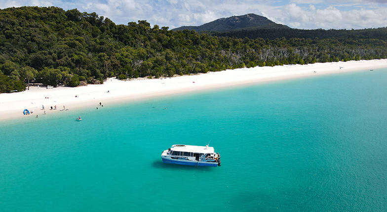 a large body of water with a mountain in the background