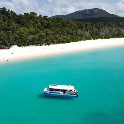 a large body of water with a mountain in the background