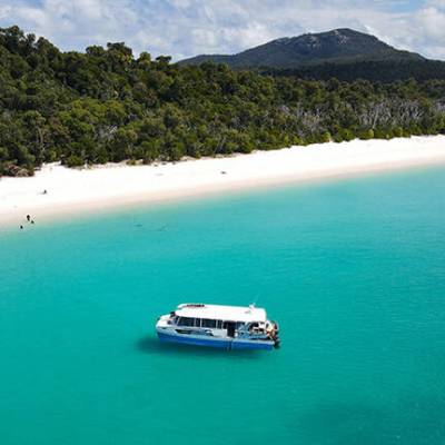 a large body of water with a mountain in the background