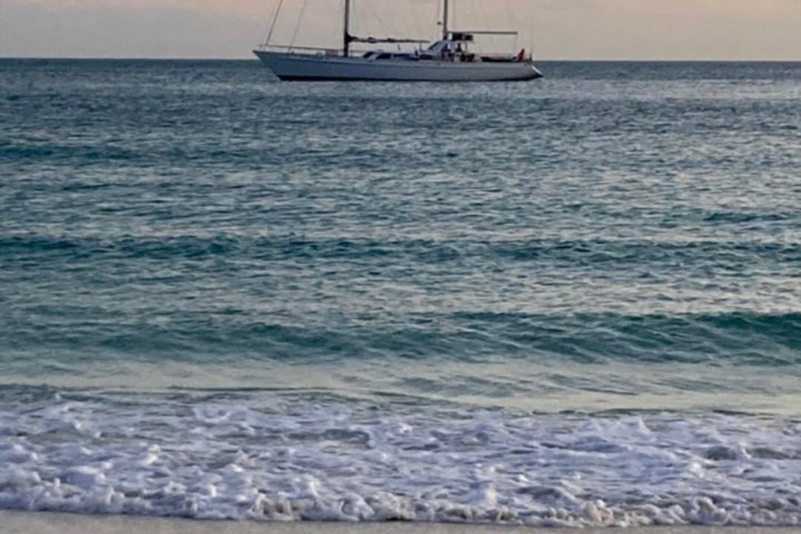 a boat on a beach near a body of water