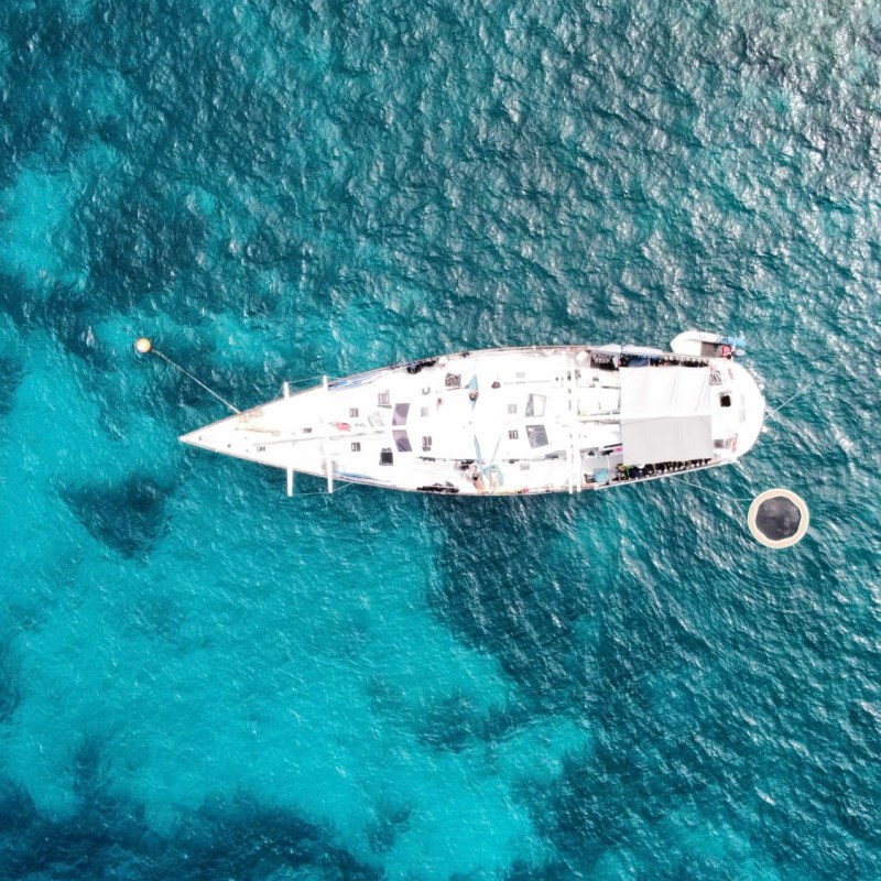 Aerial view of Summer Jo Sailing Vessel on clear blue ocean water.