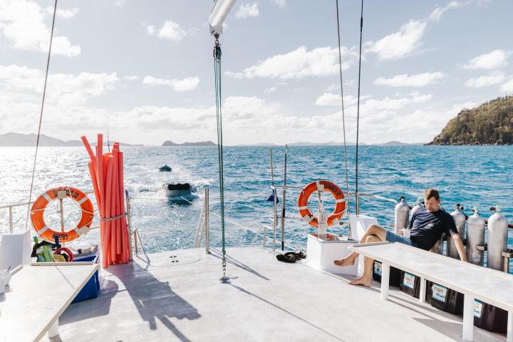 a group of people sitting at a dock
