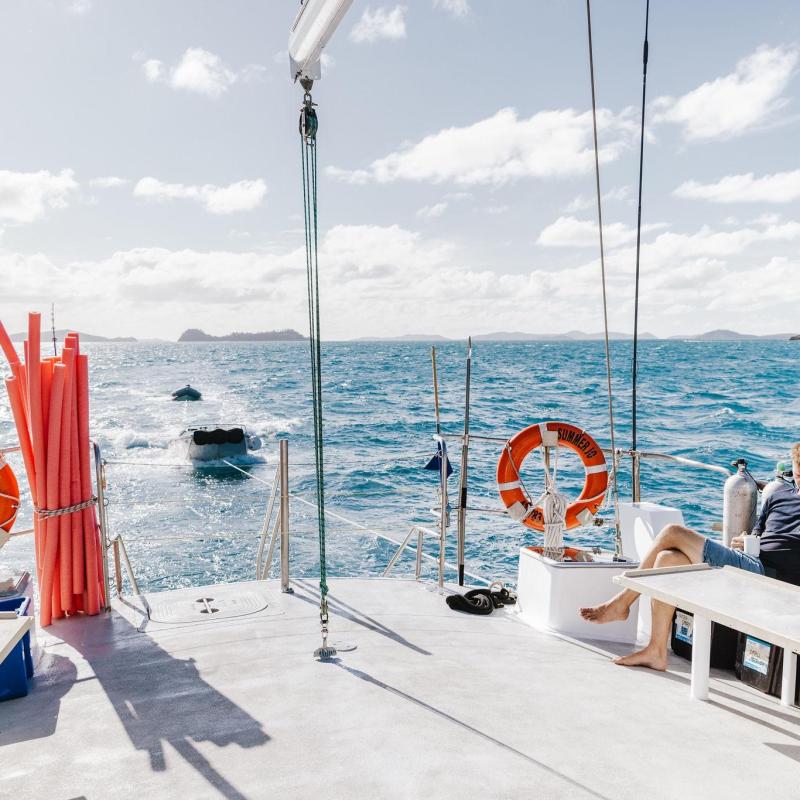 a group of people sitting at a dock