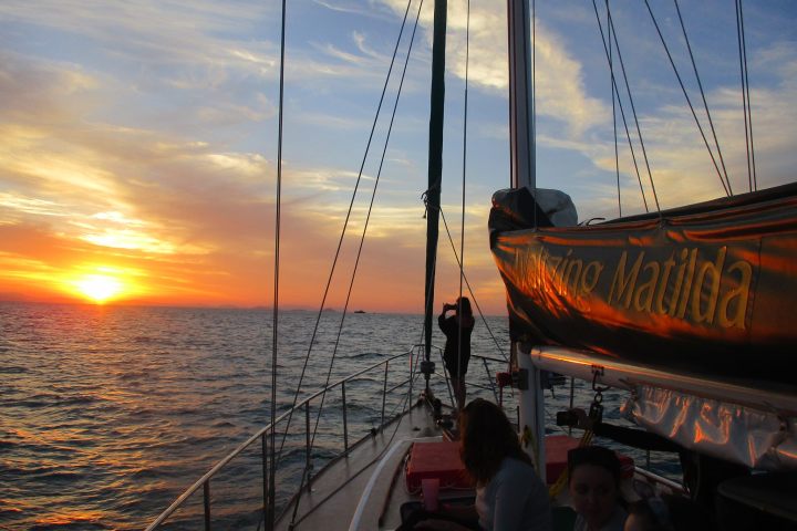 a group of people in a boat on a body of water