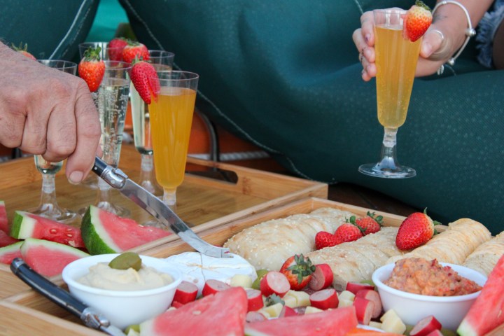 a person sitting at a table with a plate of food