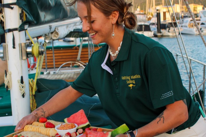 a man and a woman standing in front of a boat