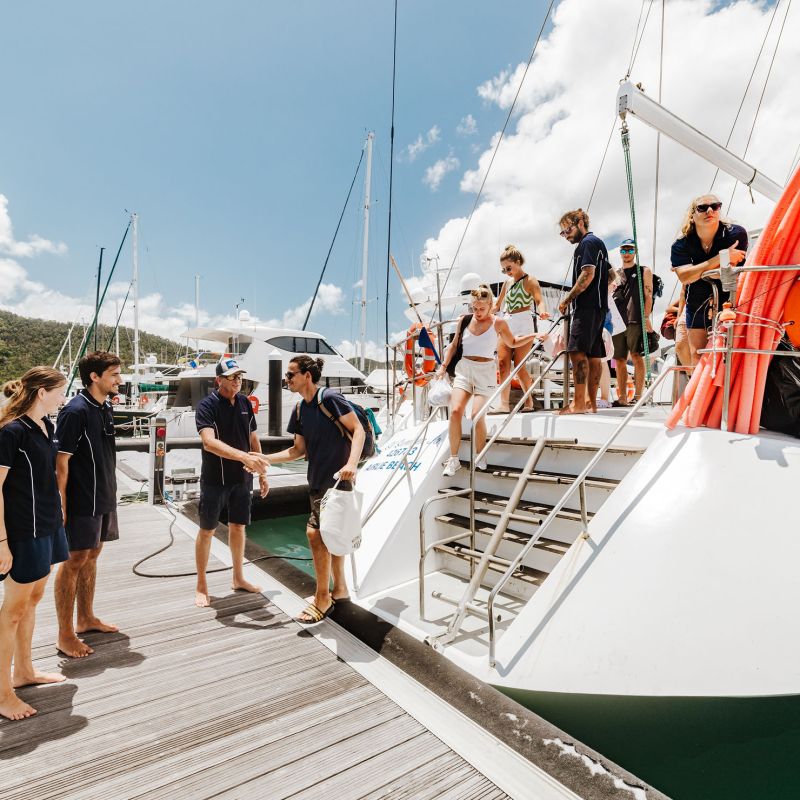 a group of people standing on a boat