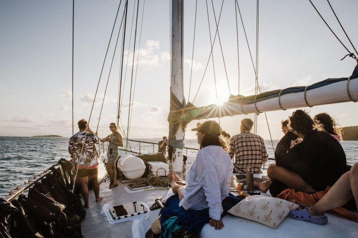 a group of people in a boat on a body of water