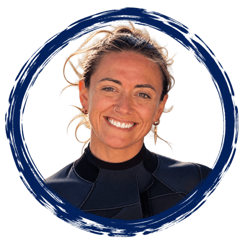 Smiling person in wetsuit with circle border.